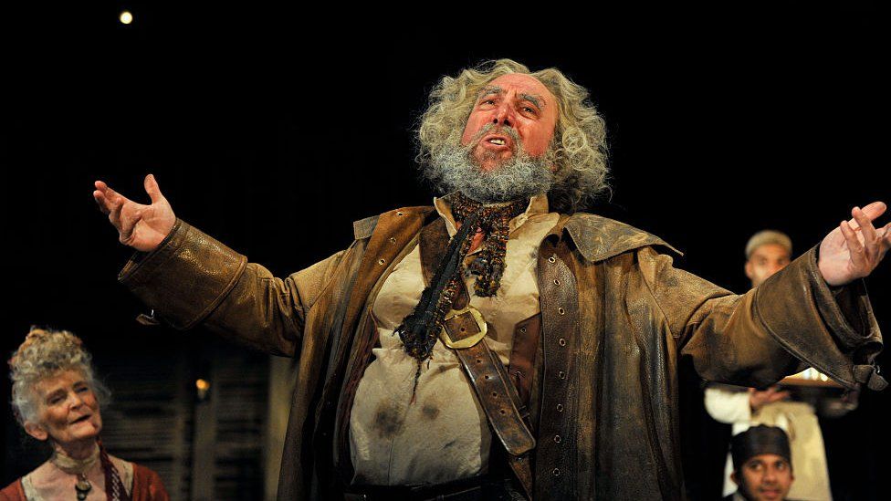 Antony Sher as Sir John Falstaff with artists of the company in the Royal Shakespeare Company's production of William Shakespeare's Henry IV part I and II