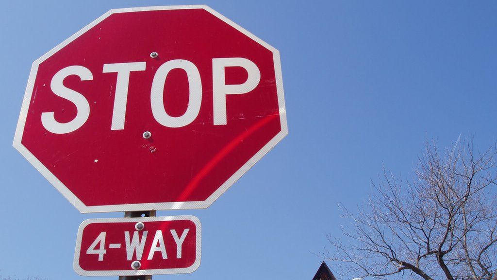 Photograph of a 4 way stop sign