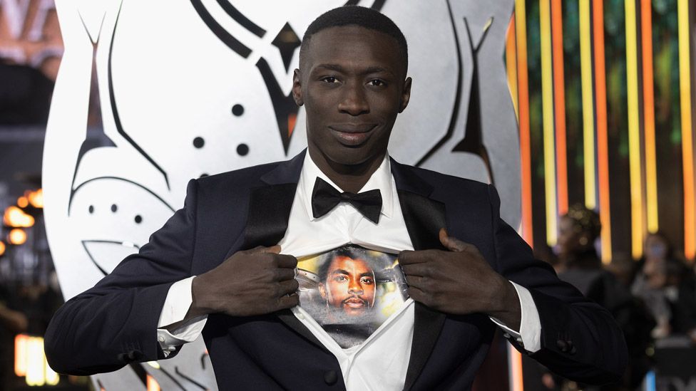 Khaby Lame wears a shirt with a picture of Chadwick Boseman as he attends the European premiere of Black Panther: Wakanda Forever
